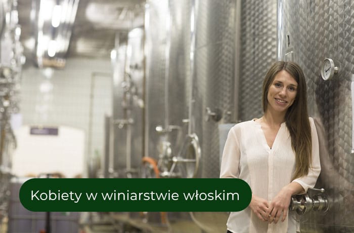 Kobieta stojąca przy kadziach do produkcji wina
