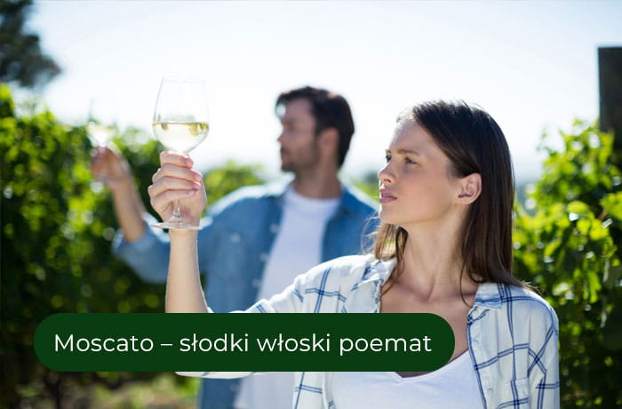 Harmonia smaku Moscato - kobieta w winnicy patrząca na kieliszek wina